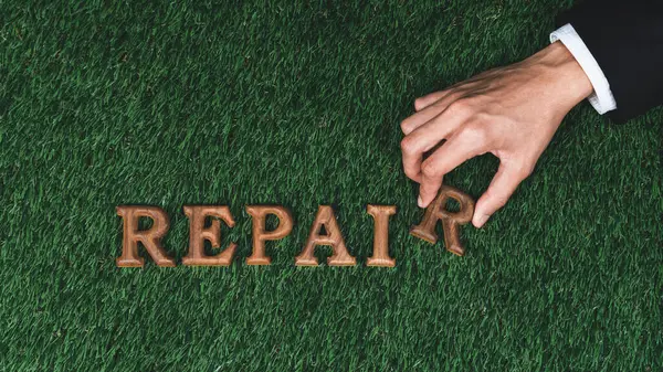 stock image Eco awareness campaign showcase businessman hand arranged message in Repair on biophilic grass background. Environmental regeneration and repair Earth concept for sustainable and greener future. Gyre