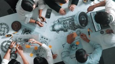 Mühendisin, toplantı masasındaki türbin motorunu ekipmanla gösteren üst düzey görüntüsü. Profesyonel proje yöneticisinin elektronik jeneratör sistemi hakkında konuştuğu ve tartıştığı hava görüntüsü. Hizalama.