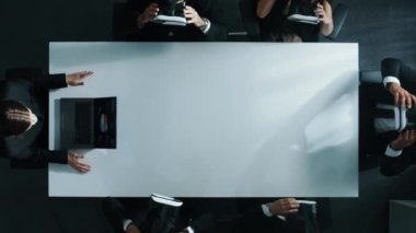 Çeşitli iş adamlarının yukarıdan aşağı görüntüsü VR kulaklık takar ve otururken ve el hareketleriyle yönetici dizüstü bilgisayarından veri depolama işlemini yaparken bulut sunucusuna bağlanır. Müdürlük.