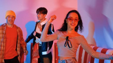 Çok kültürlü bir arkadaş birlikte dans ediyor ve hiphop müziği eşliğinde restoranda ya da kafede pembe neon ışıklı duruyor. Profesyonel sokak dansçıları grubu enerjik hareketler sergiliyor. Mutluluk.