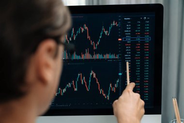 Akıllı yatırımcılar bilgisayar ekranlı ilginç borsa takasını işaret ediyorlar. Finansal teknoloji dinamik yatırım planı modern işyerindeki veri grafiğine odaklanıyor. Bireysel.