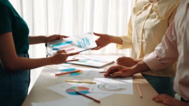Girişimci şirket çalışanları birlikte çalışır, finansal veri raporlama ve planlama stratejisi, panorama videosundaki yaratıcı iş başarısı için pazarlama içeren renkli BI gösterge panelini analiz eder. Sinerjik
