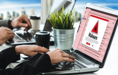 Cyber attacking concept. Malware alert showing on computer screen display scam and threat detection on computer system or online server to be removed snugly.