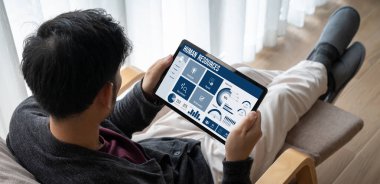 Human resources management software on computer screen helping human resources employee to manage recruitment, payroll, staff searching and KPI evaluation snugly