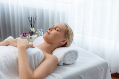 Kafkasyalı kadın müşteri stres önleyici spa masajının keyfini çıkarıyor ve lüks otel ya da oteldeki gündüz açık ortam güzellik salonunda güzellik teniyle eğleniyor. Sessiz.