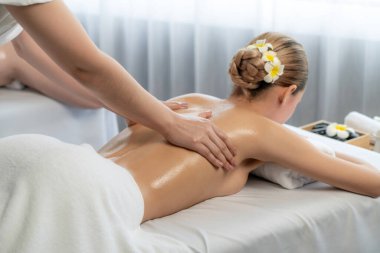 Kafkas çift müşterisi stres önleyici spa masajının keyfini çıkarıyor ve lüks otel veya oteldeki gündüz açık hava ortamında güzellik teniyle eğleniyor. Sessiz.
