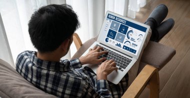 Human resources management software on computer screen helping human resources employee to manage recruitment, payroll, staff searching and KPI evaluation snugly