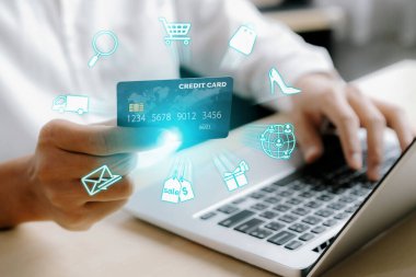 Beyaz tişörtlü, elinde kredi kartı olan şık bir müşteri çevrimiçi platform seçiyor. Açık e-ticaret uygulaması nakitsiz teknoloji alışveriş envanteri kullanırken akıllı tüketiciler dizüstü bilgisayar kullanıyor. Siber Nakit.
