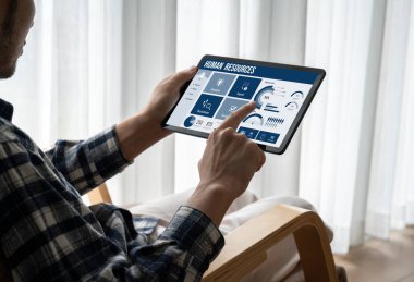 Human resources management software on computer screen helping human resources employee to manage recruitment, payroll, staff searching and KPI evaluation snugly