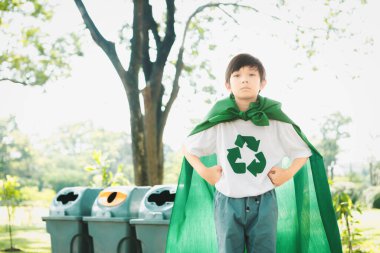 Cheerful young superhero boy with cape and recycle symbol promoting waste recycle, reduce, and reuse encouragement as beacon of eco sustainable awareness for future generation. Gyre clipart