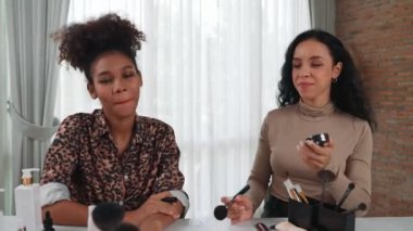 İki kadın nüfuzlu kişi canlı yayında video görüntülerini çekiyor. Makyaj çok önemli sosyal medya veya blog. Kozmetik stüdyosu ışıklandırmalı mutlu genç kız çevrimiçi pazarlama oturumu yayını için..