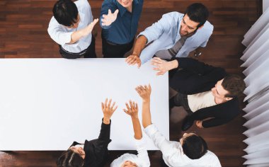 Panorama afişi çeşitli ofis çalışanlarından oluşan bir grup toplantı masasında el ele verecek. İş sinerjisi ve iş yerinde üretken bir takım çalışması. İş adamlarının birlik ve beraberliği. Tedbirli