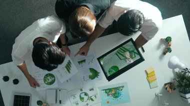 Top aerial view of businessman and manager talking about clean energy investment. Aerial view of business team working together planning to use renewable energy. ESG modern development. Alimentation. clipart