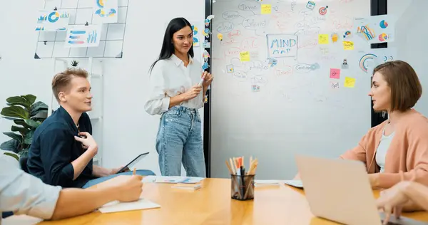 stock image Young beautiful leader presents marketing strategy while expert investor and project manager lecturing to analyze business performance at start up business meeting. Multiethnic group. Immaculate.