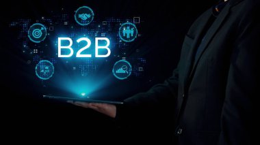 İş adamı B2B peyzajında geziniyor, iş-iş bağlantılarını geliştirmek için kullanım teknolojisi kullanıyor. B2B etkileşimini yeniden şekillendiren keşifler, iş-iş stratejilerinde yenilikleri yönlendiren araçlar. Kullanıcı Kimliği