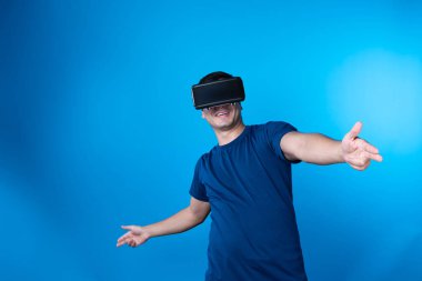 VR takan akıllı oyuncu metaevren dünyasına dönüyor, silah avcılığı oynuyor, mavi arka planda zafer hayvan avcılığı yapan fütüristik teknoloji hologramına bağlanıyor, sanal gerçeklik. Entrika.