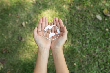 Top view hand holding Earth planet icon symbolize eco-friendly commitment to environmental protection and zero carbon emission. Earth World Day concept to promote eco awareness. Gyre clipart