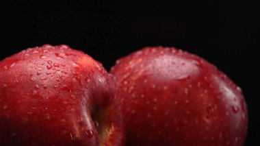 A fresh red apples, showcasing its crisp and white flesh, rests dramatically against a stark black background. The smooth, apple-crisp surface, Apple slice with separated black background. Comestible. clipart