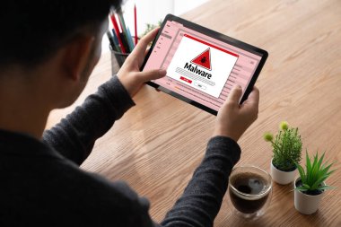 Cyber attacking concept. Malware alert showing on computer screen display scam and threat detection on computer system or online server to be removed snugly.