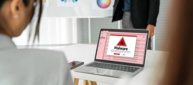 Cyber attacking concept. Malware alert showing on computer screen display scam and threat detection on computer system or online server to be removed snugly.