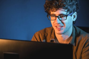 Genç işadamı, Neon Light Modern Ofis 'te yaratıcı bir başlangıç projesi için bilgisayara odaklanıyor. Düşünüyorum da, pazarlama ağı yaratıcıdan pazar kanalı tasarım konseptine çevrimiçi planlama. Toplayıcı.