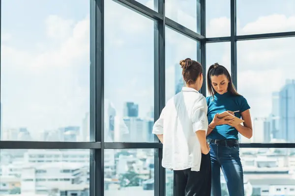 stock image Portrait of young beautiful professional architect engineer team discuss about house design. Skilled businesswoman brainstorming and sharing marketing ideas surrounded by skyscraper. Tracery.