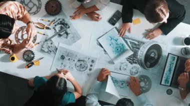 Türbin motoru tasarlamak için çalışan akıllı mühendis takımının yukarıdan aşağıya hava görüntüsü. Profesyonel teknisyen jet motoru yapımını tartışırken motorun bir kısmını işaret ediyor. Hizalama.