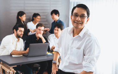 Ofiste çalışan iş arkadaşı ve iş adamlarının geçmişine sahip özgüven ve mutlu gülümseyen iş adamı portresi. Ofis çalışanı takım çalışması ve pozitif iş yeri konsepti. Tedbirli