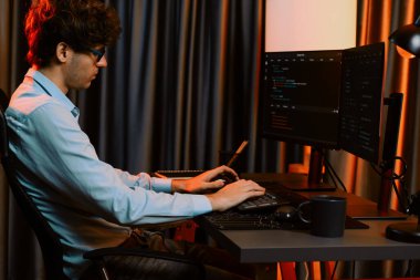 Uygulama pc ekranları ile çevrili çevrimiçi yazılım geliştirme bilgilerini yoğunlaştıran IT geliştiricisi, neon modern ofis evindeki web sitesinde yazılım için program yaratıyor. Toplayıcı.