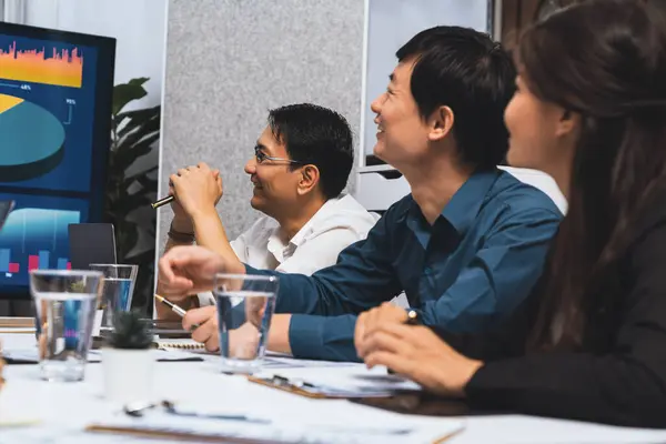 stock image Analyst team utilizing BI Fintech to analyze financial data at table in meeting room. Businesspeople analyzing BI dashboard power for business insight and strategic marketing planning. Prudent