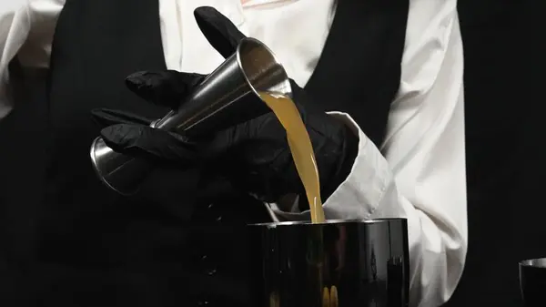 stock image Macrography, witness the skillful hands of a bartender as they expertly mix a cocktail against a striking black background. Each close-up shot capture the fluid motion and dynamic energy. Comestible.