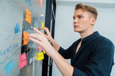 Kafkasyalı profesyonel iş adamının zihin haritası ve renkli yapışkan notlar kullanarak iş pazarlama fikrini kendine güvenle sunuşunun yakın görüntüsü. Proje konseptini başlat. Portre. Tertemiz..