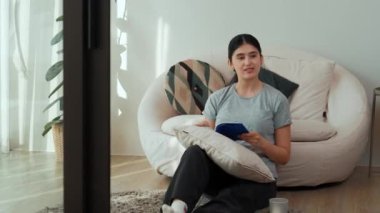 Kanepede oturan orta yaşlı bir kadın, sosyal ve teknolojik mesleki gelişmeler hakkında ders kitabı okur ya da zeki bir anne olmak için çocuk yetiştirir. Hayat boyu öğrenme konsepti. Uyumsuzluk.