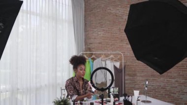 Kadın nüfuzlu kişi canlı yayında video görüntülerini çekiyor. Makyaj çok önemli sosyal medya ya da blog. Kozmetik stüdyosu ışıklandırmalı mutlu genç kız çevrimiçi pazarlama oturumu yayını için..