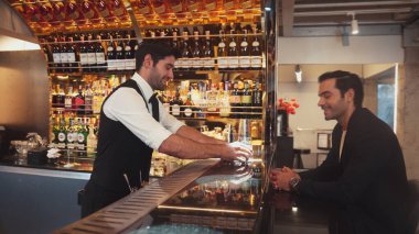 Akıllı barmen, lüks bir tezgahta arkadaşını beklerken limonlu cin kokteyli ikram ediyor. Barmen, canlı gece hayatı parti atmosferinde mükemmel hizmet veriyor. Vinosity.