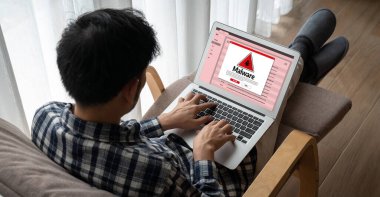 Cyber attacking concept. Malware alert showing on computer screen display scam and threat detection on computer system or online server to be removed snugly.