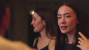 Lüks bir kokteyl barında grup arkadaşıyla gülümseyen güzel bir kadının portresi. Gece kulübünde sosyetik etkileşim için doğal yüz güzelliğini kostüm içinde yakalamak. Vinosity.