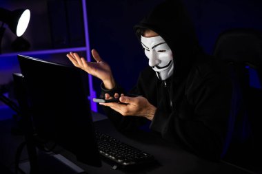 White smiling criminal anonymous mask calling to victim, convince to hack personal information, making share screen encryption program by hacker application on data server system in privacy. Surmise. clipart