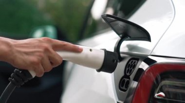 Elle şarj EV şarj prizi tutucusu elektrikli arabaya bağlanıyor, EV araba aküsünü temiz çevre için sıfır CO2 emisyonu ile alternatif ve sürdürülebilir enerjiyle şarj ediyor. Titiz
