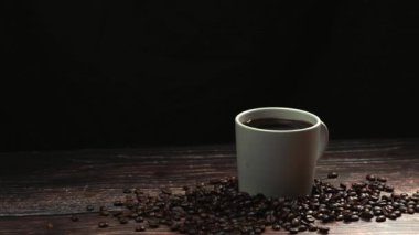 Kahve fincanının içine düşen buz tabakası ve siyah arkaplanla sıçrayan çok yavaş bir çekim. Etrafı kahve çekirdeği yığınıyla çevrili olan espresso 'nun içine şeker damlacıklarını kapatın. Hareket atışı. Geliştirilebilir.