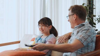 Grandfather and granddaughter together watch interesting entertainment media on TV. Old senior use technology communicate with young generation cross generation gap strengthen family bond. Divergence. clipart