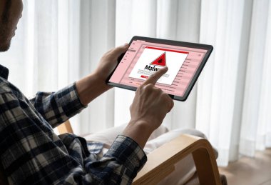 Cyber attacking concept. Malware alert showing on computer screen display scam and threat detection on computer system or online server to be removed snugly.
