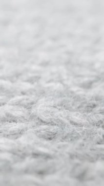 Makro doli çekimde koyun yünü kumaş dokusunun aşırı detaylı görünümü. El işi örgü örmek için akıcı hayvan lifleri. Tekstil soyut arka planı. Kışın moda endüstrisi.
