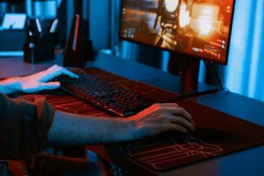 Genç oyun flamasının sunucu kanalı, bilgisayar ekranında çoklu oyuncuyla savaş oyunu oynayan, dijital neon odasında mikrofonlu kulaklık takan bilgisayar. Toplayıcı.