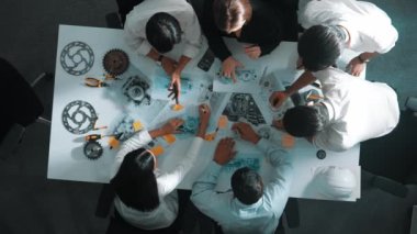 Mühendisin, toplantı masasındaki türbin motorunu ekipmanla gösteren üst düzey görüntüsü. Profesyonel proje yöneticisinin elektronik jeneratör sistemi hakkında konuştuğu ve tartıştığı hava görüntüsü. Hizalama.