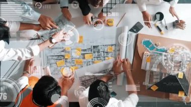 Kaliteli mimar mühendis ekibinin ev tasarlamak için birlikte çalışmasına tepeden aşağı bir bakış açısı. Proje yöneticisinin hava görüntüsü inşaatı finansal ve istatistiksel olarak gösteriyor ve açıklıyor. Hizalama.