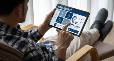 Human resources management software on computer screen helping human resources employee to manage recruitment, payroll, staff searching and KPI evaluation snugly