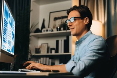 Akıllı iş adamı iş paragrafı dinamik pazarlama analizi planını analiz ediyor. Kağıt kağıtları ve bilgisayar monitörü raporlarını gece evdeki belge verileriyle karşılaştırmak için hazırlıyor. Bireysel.