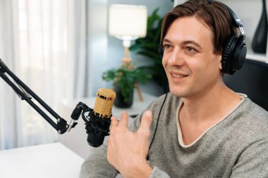 Sunucu kanalı, gülümseyen akıllı yayıncı kaydı, senaryosu ve akıllı telefonuyla sosyal medyada sohbet programı, kulaklık takarak modern ev stüdyosundaki video flamalarını kaydediyor. Bireysel.