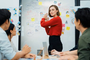 Profesyonel çekici kadın lider, modern iş toplantı odasında beyin fırtınası zihin haritalama istatistikleri ve renkli yapışkan notlar kullanarak yaratıcı pazarlama planını sunuyor. Tertemiz..